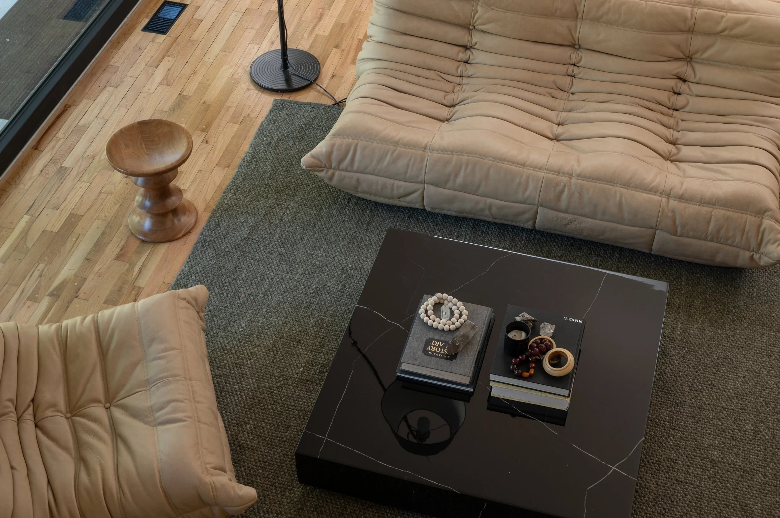 Low cream lounge chairs around a dark coffee table